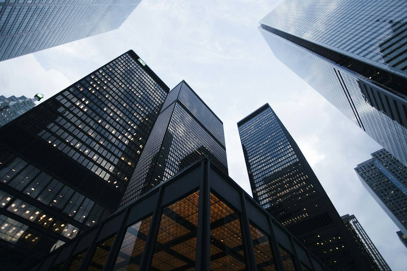 Looking up between glass towers in a financial district