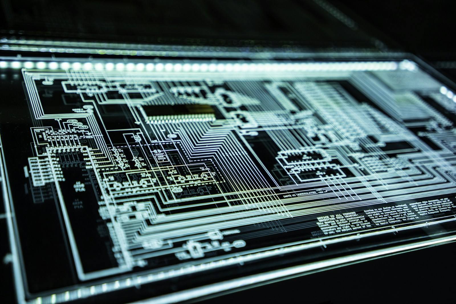 Macro view of a luminous circuit board representing layered technical security